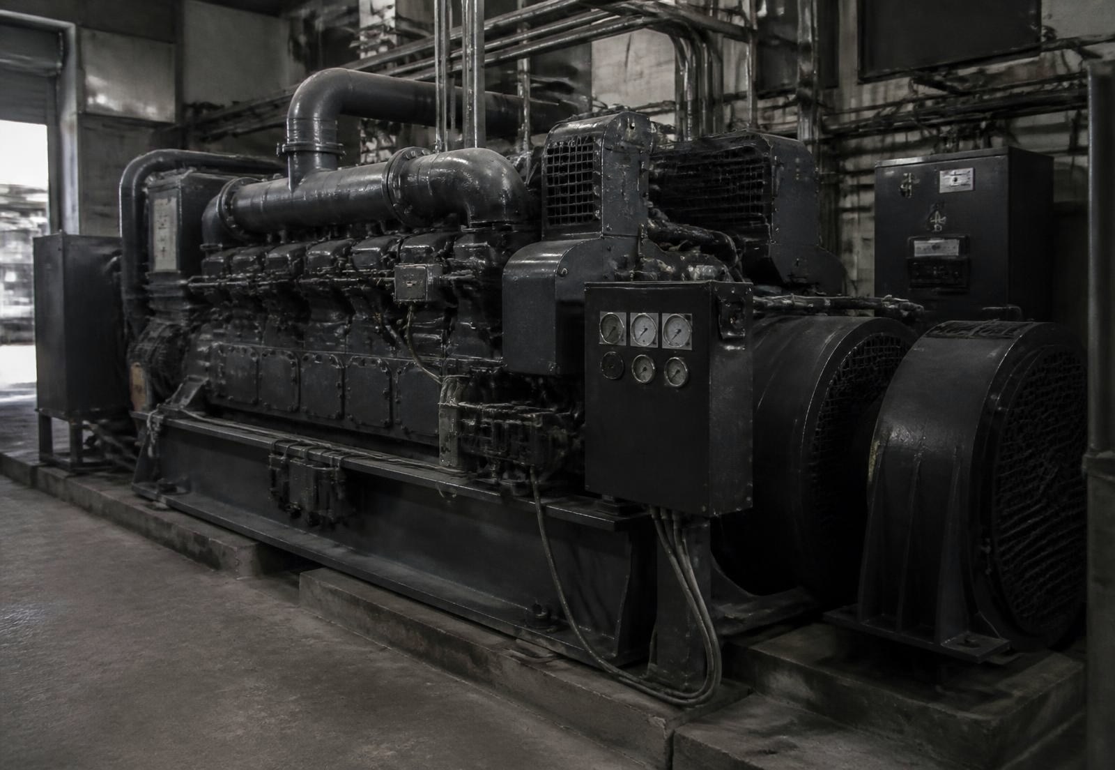 Large industrial diesel engine installation inside a plant